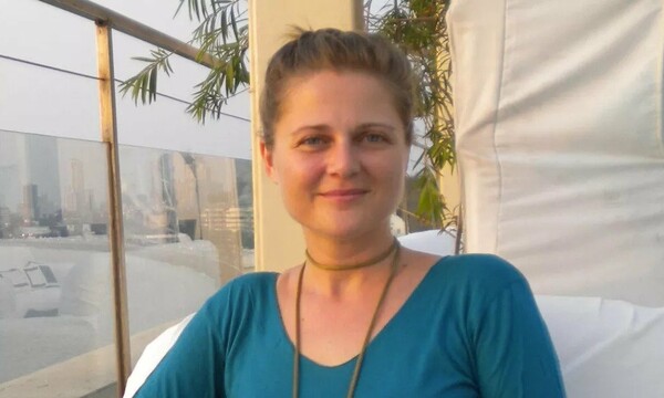 Jennifer beside a window