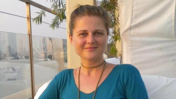 Jennifer beside a window